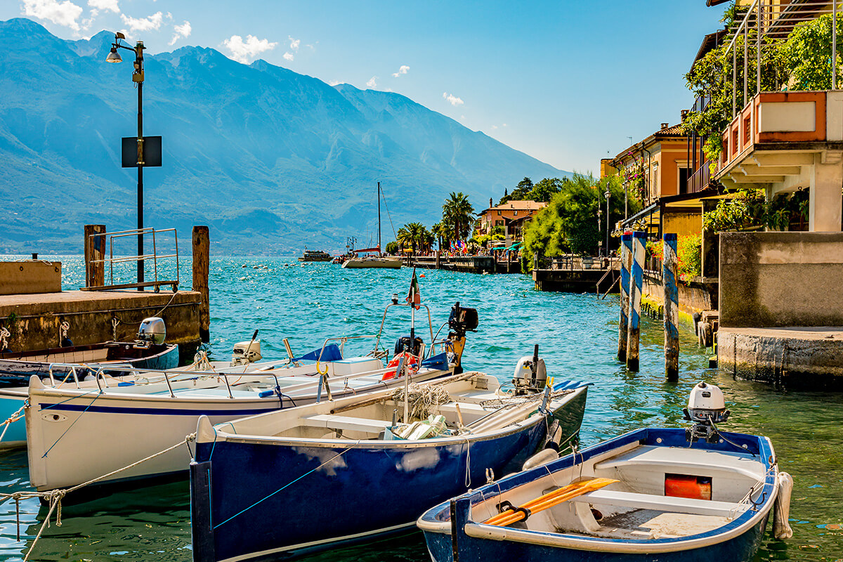 Boats tied to a dock with a mountain in the background