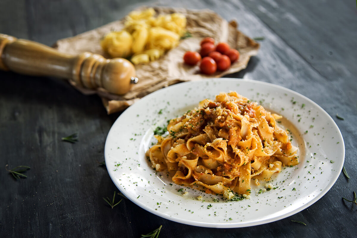 A plate of pasta on a rustic-looking table